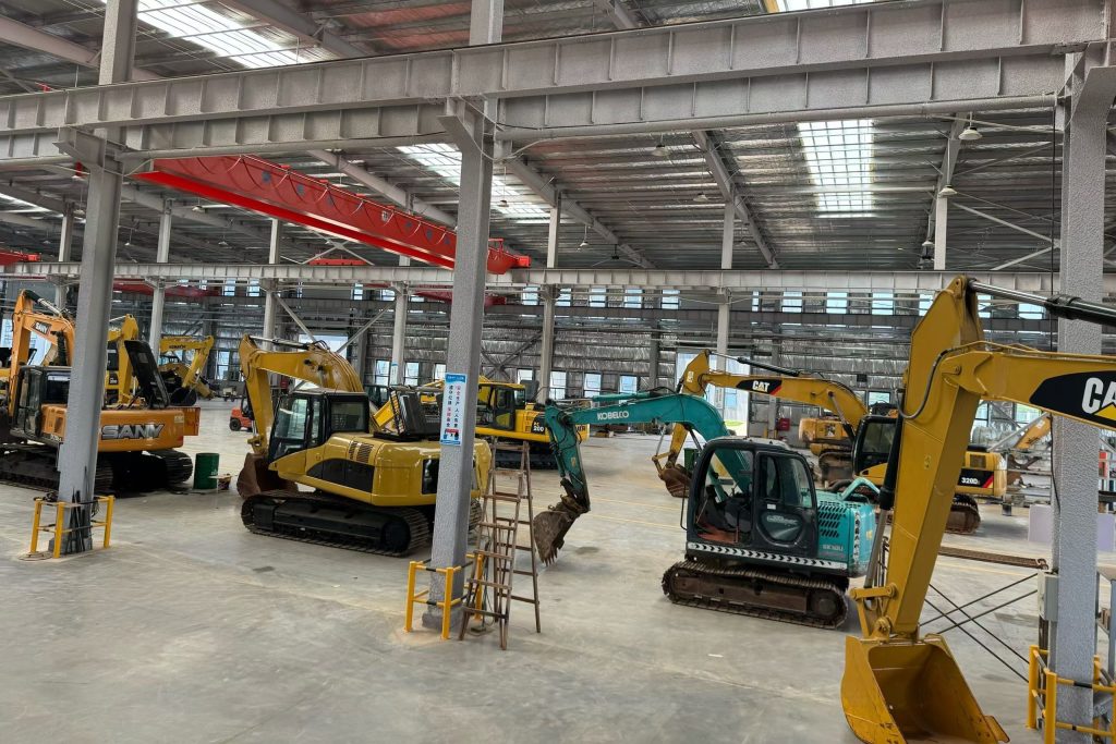Used excavators inside our machinery refurbishment factory in China